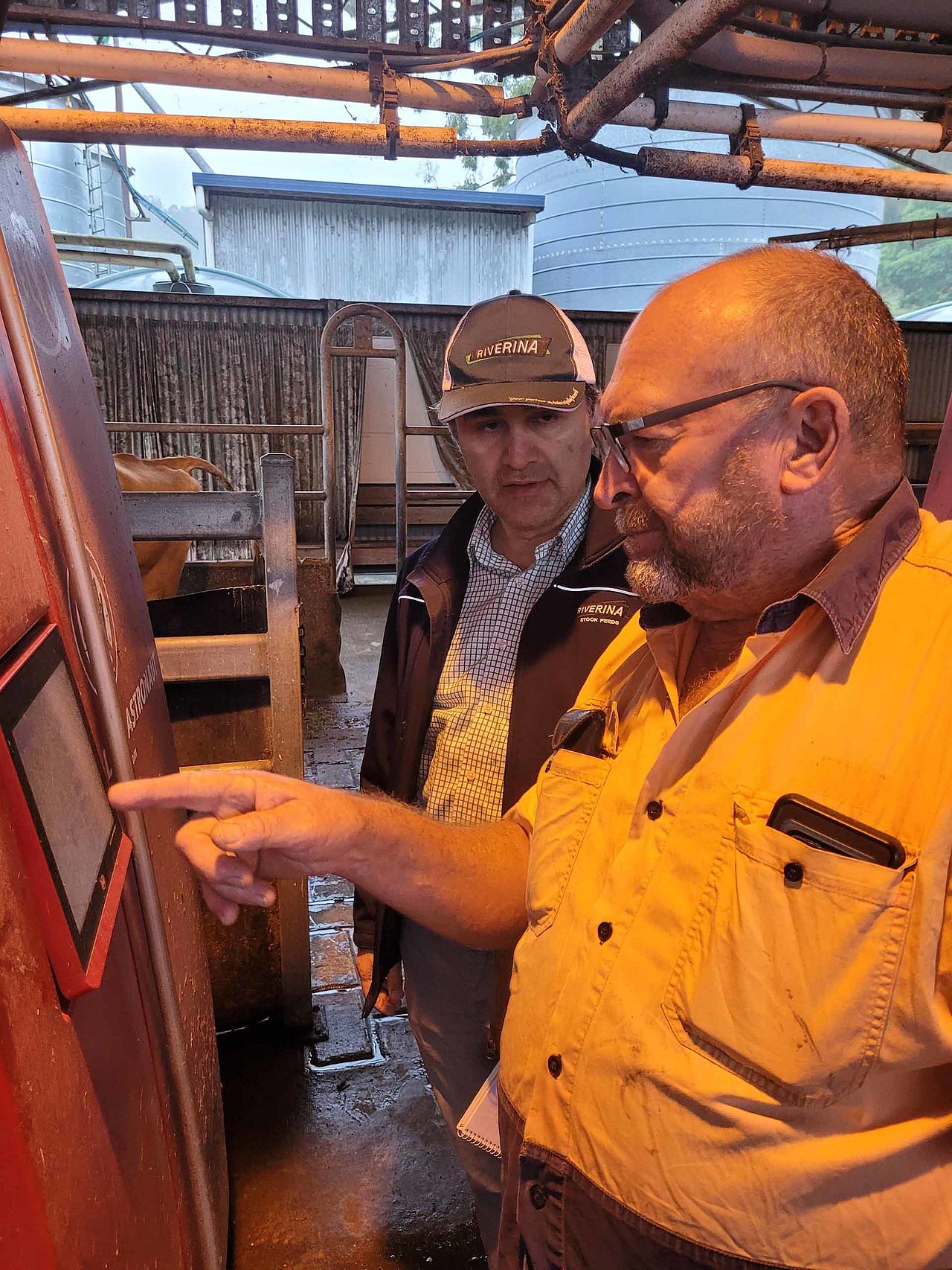 Two Riverina members discussing equipment in a workshop